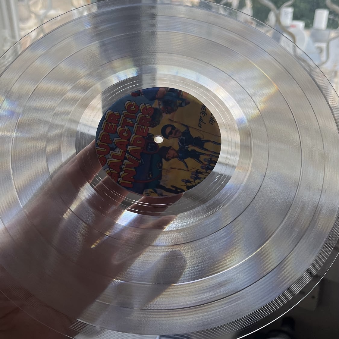 Clear vinyl lathe cut record with Super Galactic Invaders comic label