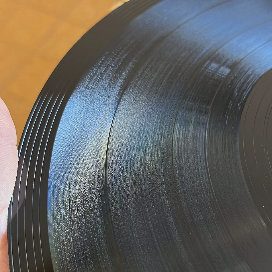 Macro close-up of lathe cut grooves on black vinyl