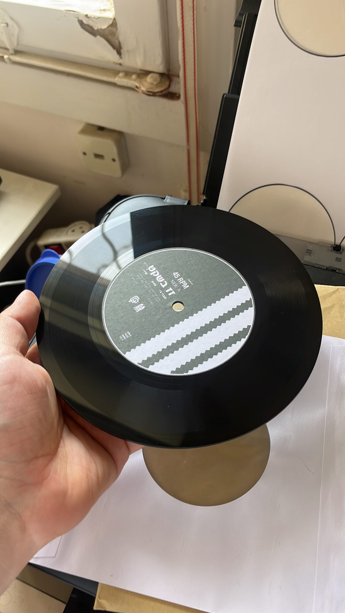 7-inch lathe cut vinyl with a custom grey 45RPM center label by PLASTIK